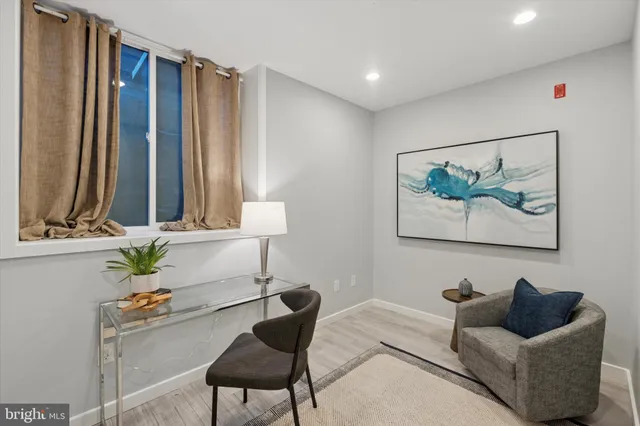 a bedroom with furniture and a large window