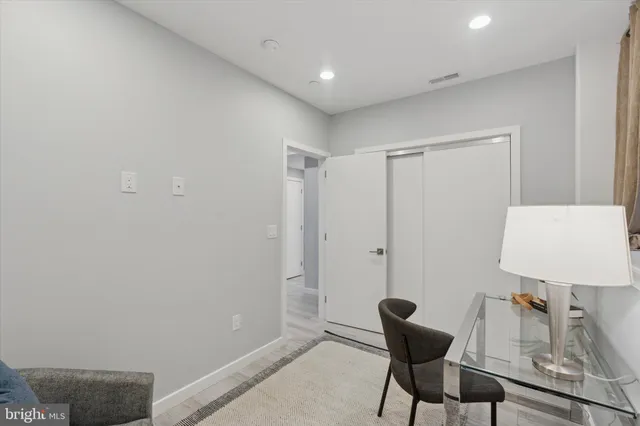 a view of a room with furniture and wooden floor