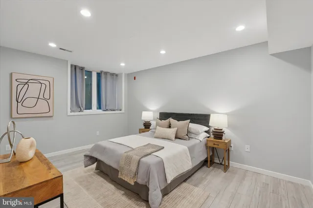 a bedroom with a bed and night stand