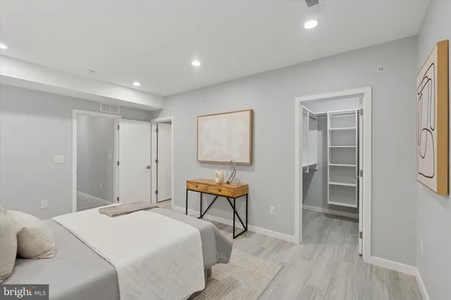 a bedroom with a bed and a lamp on table