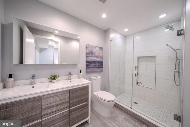 a hallway with wooden floor furniture and a living room
