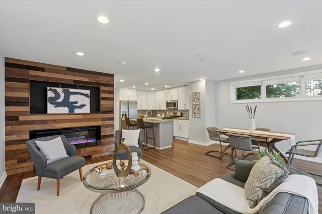 a living room with furniture and a dining table with kitchen view