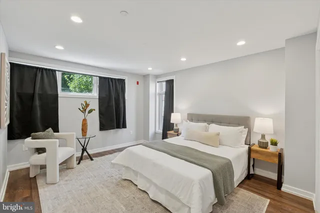 a bedroom with a bed and a mirror