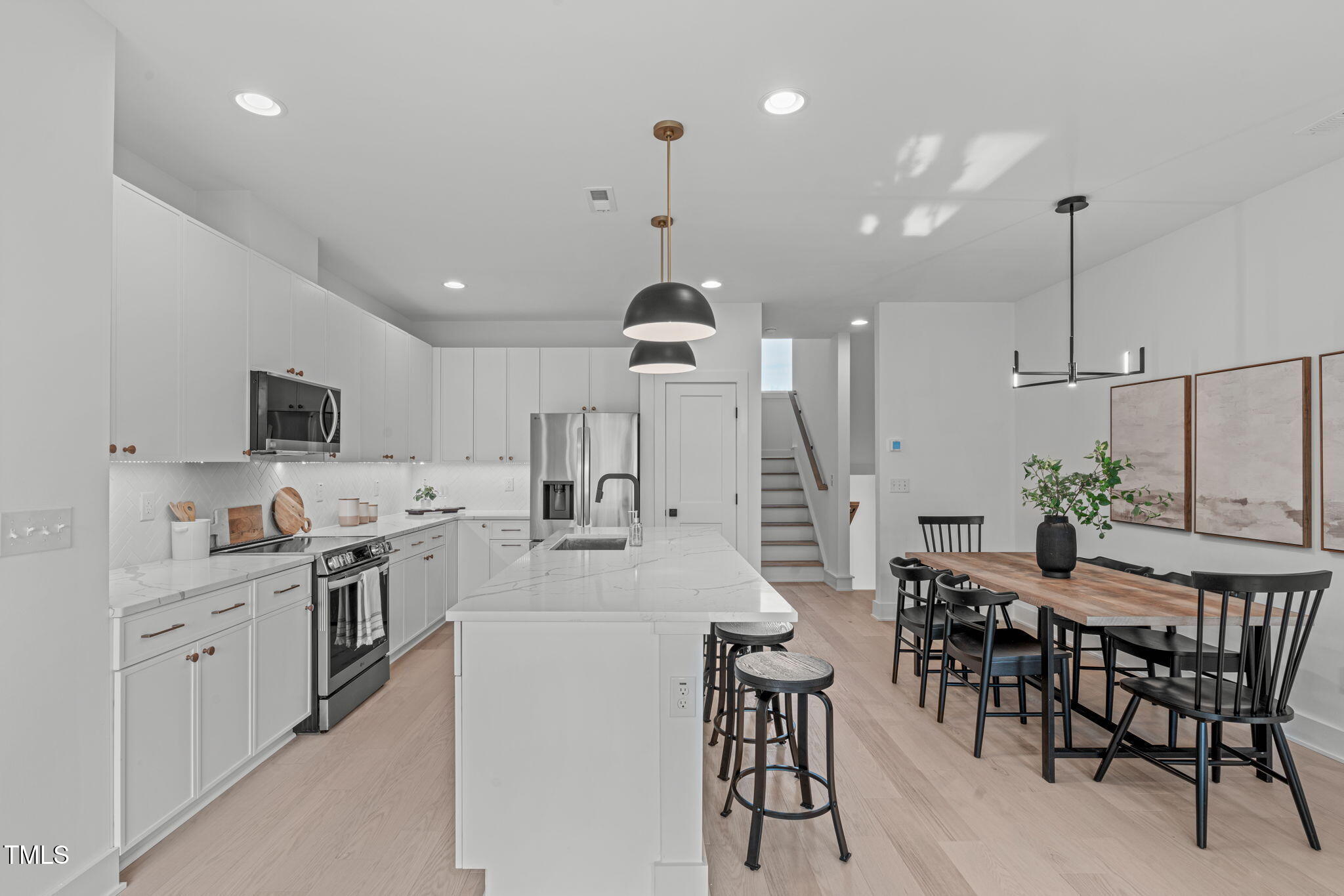 622 Rocky Knob Court Raleigh, NC 27601 - Photo 10 of 47 a kitchen with kitchen island a dining table chairs stainless steel appliances and cabinets