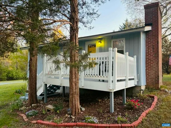 a view of a chair and table in backyard of the house