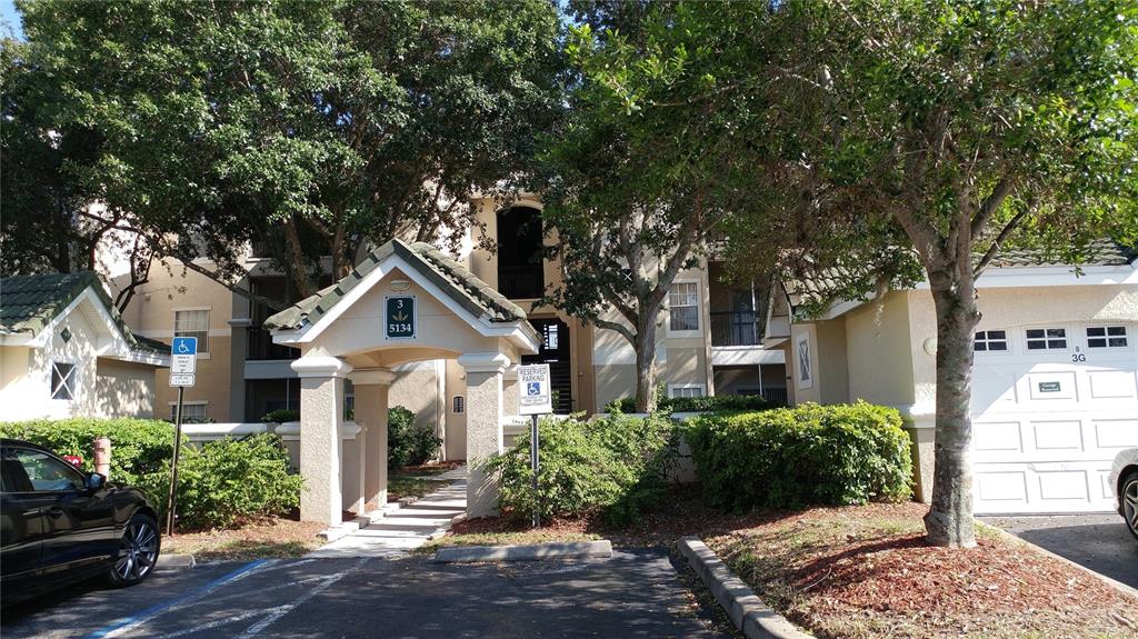 5134 Northridge Road, Unit 308 Sarasota, FL 34238 - Photo 1 of 1 a front view of a house with a yard
