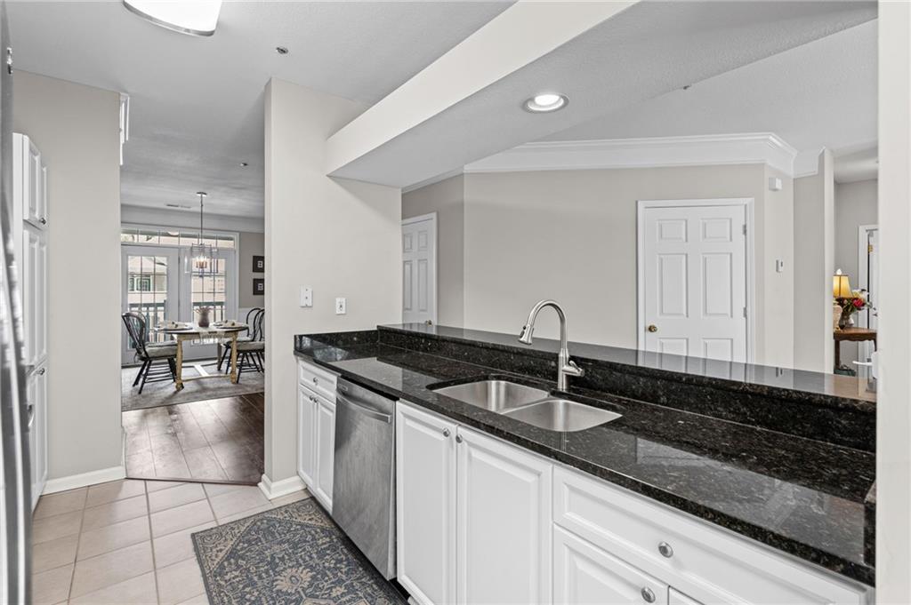 238 Edinburgh Court Alpharetta, GA 30004 - Photo 5 of 20 a kitchen with granite countertop a sink and cabinets