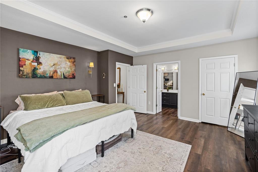 238 Edinburgh Court Alpharetta, GA 30004 - Photo 8 of 20 a spacious bedroom with a bed and a flat screen tv