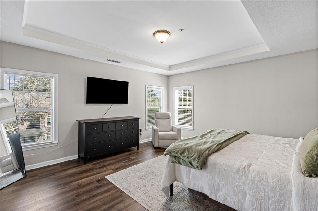 238 Edinburgh Court Alpharetta, GA 30004 - Photo 9 of 20 a bedroom with a bed and a flat screen tv