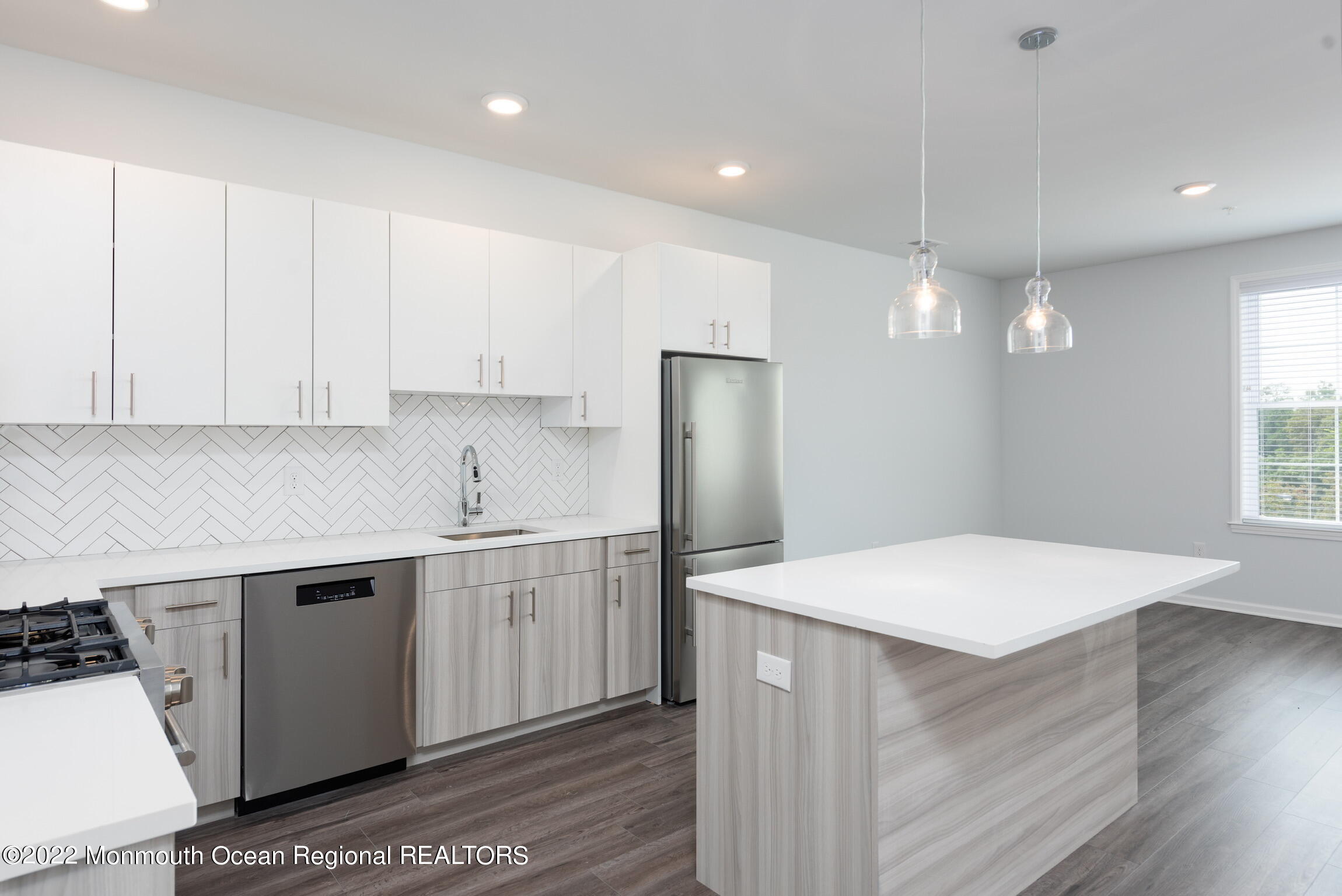 24 Mechanic Street, Unit 405 Red Bank, NJ 07701 - Photo 4 of 17 a kitchen with a sink a stove a refrigerator and white cabinets