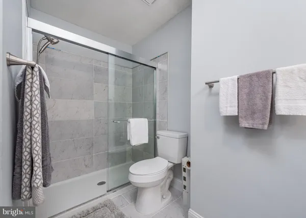 a bathroom with a shower a toilet and a sink