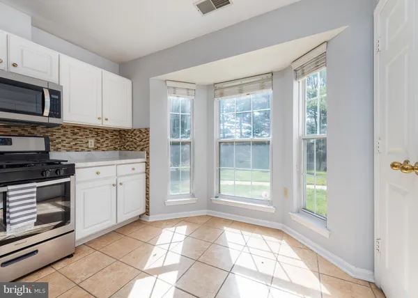 a kitchen with a stove a sink and a refrigerator