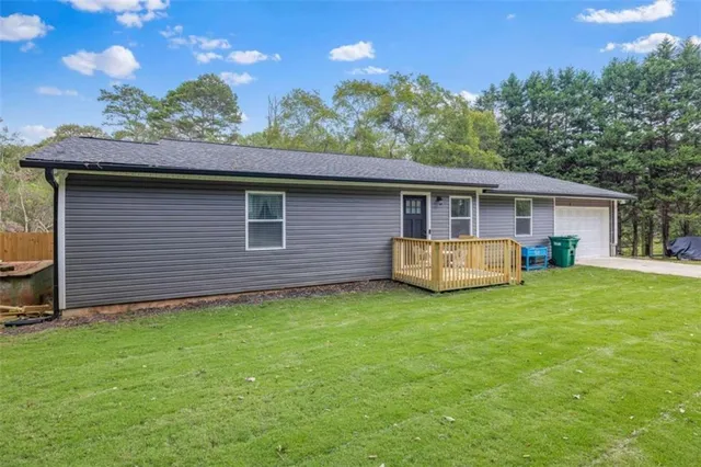 a backyard of a house with barbeque oven table and chairs