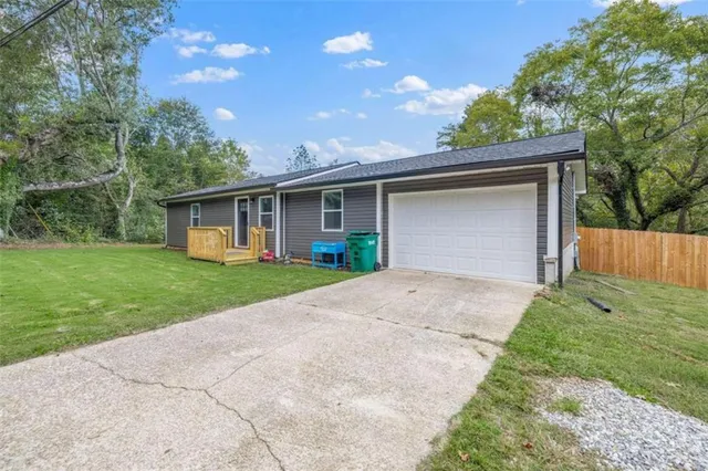 a front view of house with yard and green space