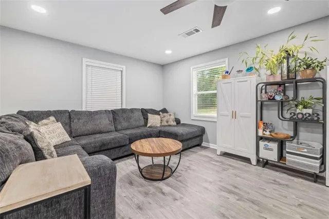 a living room with furniture a rug and a chandelier