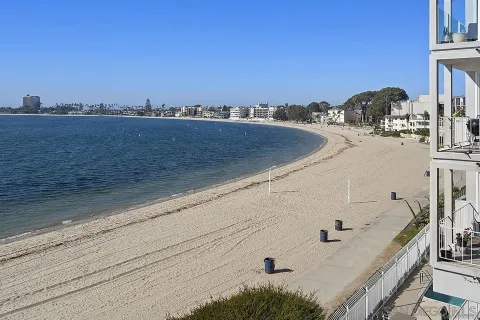 a vase of flowers sitting on a table in front of a window