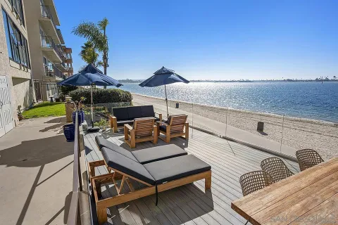 a dining room with furniture a chandelier and wooden floor