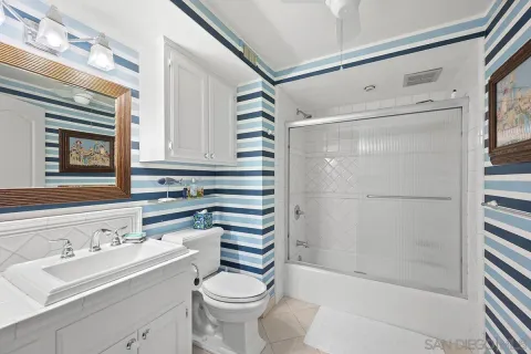 a bathroom with a tub a double vanity sink and a mirror