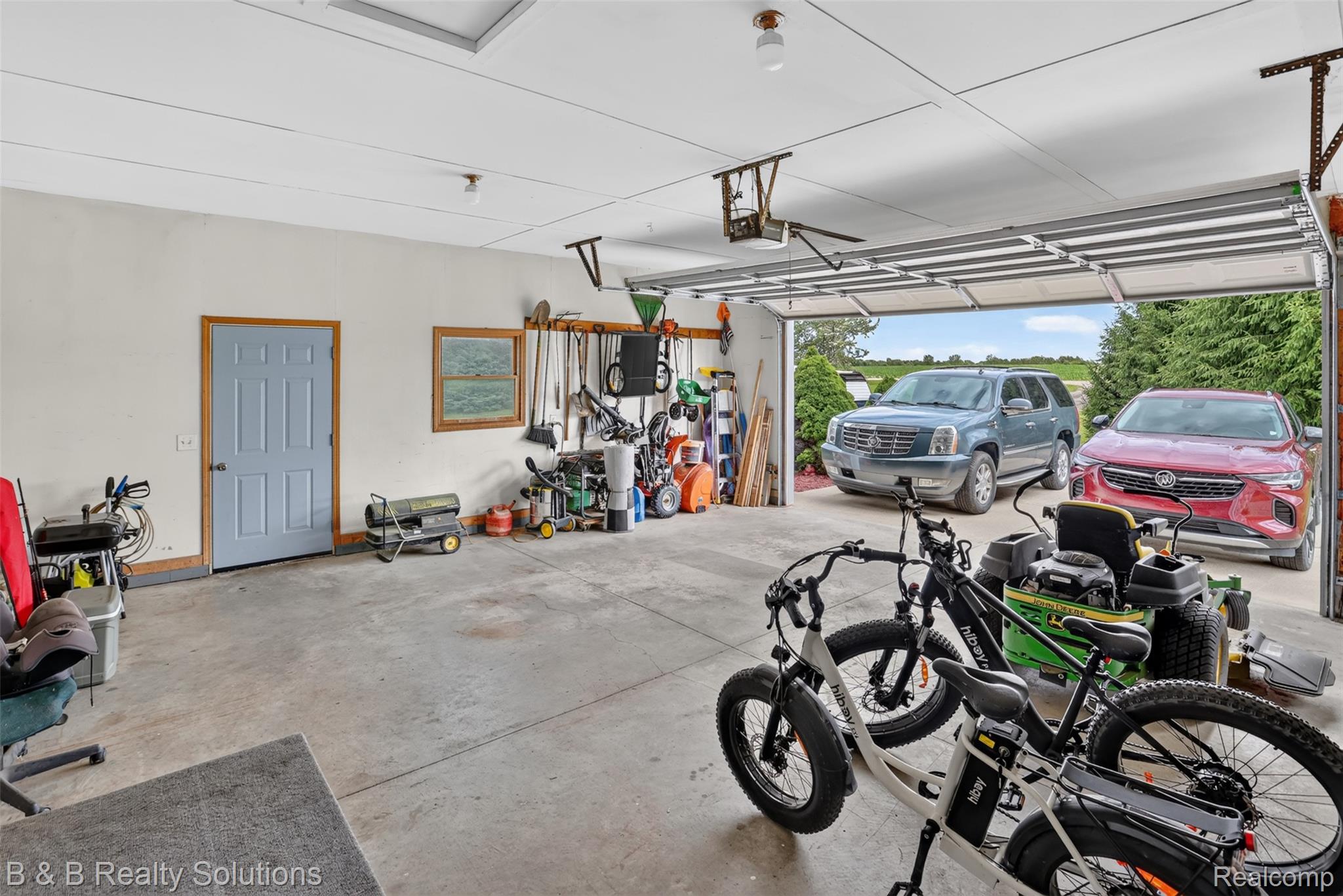 3097 East Burnside Road North Branch, MI 48461 - Photo 40 of 52 Spacious garage featuring a concrete floor, overhead lighting, and a large garage door