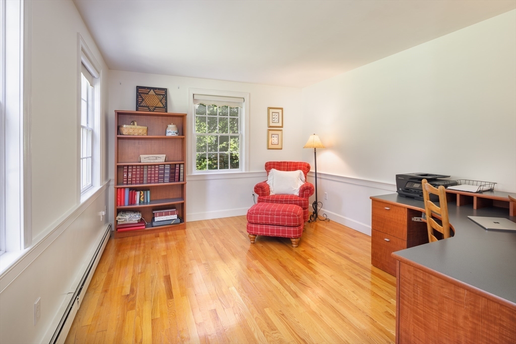 53 South Hampton Road Amesbury, MA 01913 - Photo 23 of 39 a living room with furniture and a book shelf