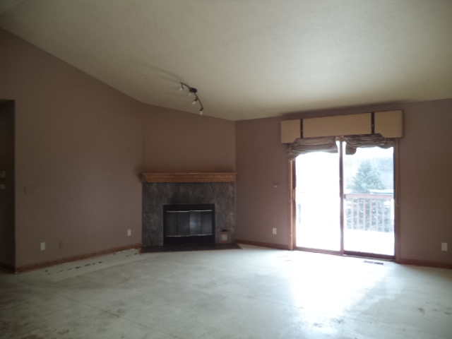 17529 Burr Oak Road Capron, IL 61012 - Photo 5 of 21 an empty room with fireplace and windows