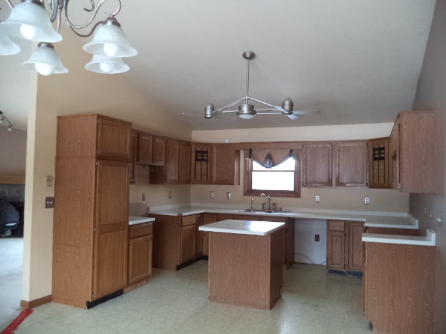 17529 Burr Oak Road Capron, IL 61012 - Photo 8 of 21 a kitchen with stainless steel appliances granite countertop a sink a stove a refrigerator cabinets and a window
