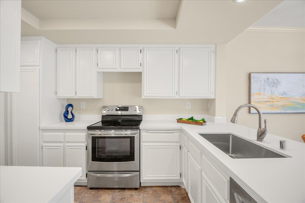 a kitchen with white cabinets and white appliances