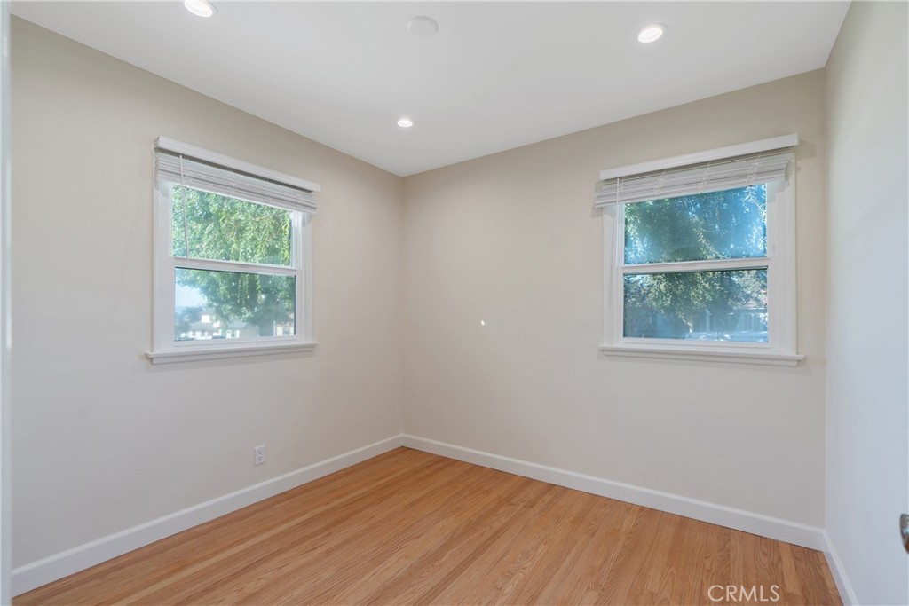 3054 North Frederic Street Burbank, CA 91504 - Photo 16 of 21 an empty room with wooden floor and windows