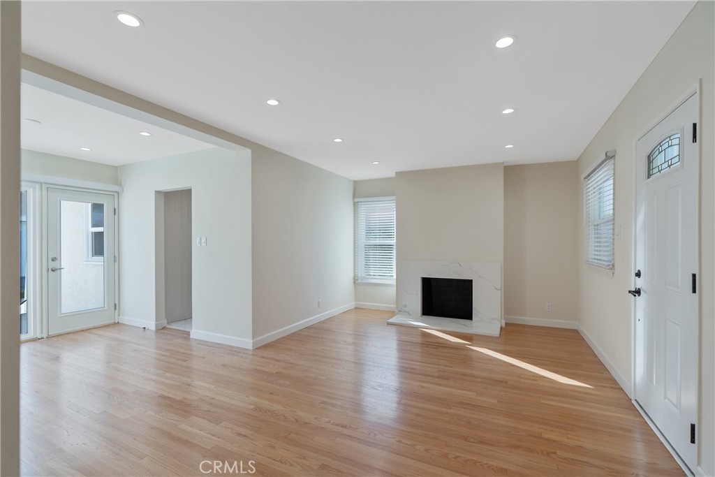 3054 North Frederic Street Burbank, CA 91504 - Photo 4 of 21 an empty room with wooden floor and fireplace