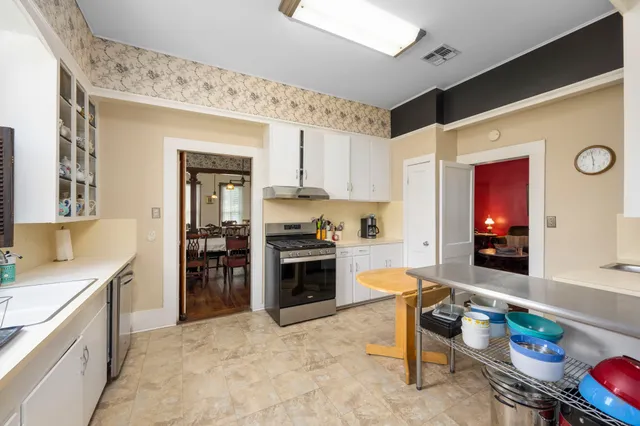a kitchen with stainless steel appliances granite countertop a refrigerator and a stove top oven