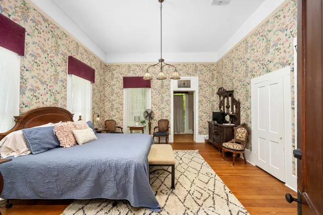 a bedroom with furniture and a chandelier