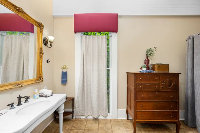 a bathroom with a sink vanity and a mirror