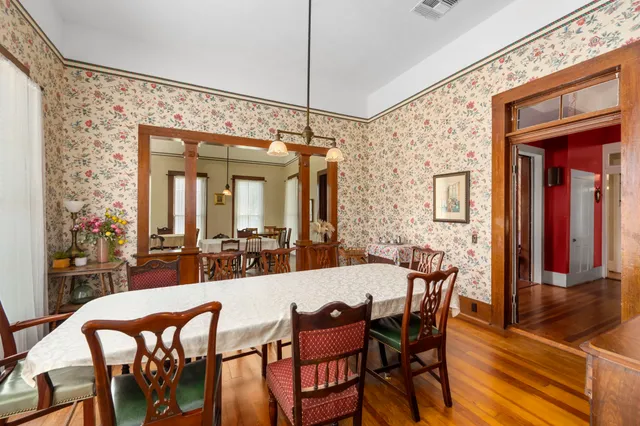 a view of a dining room with furniture and wooden floor