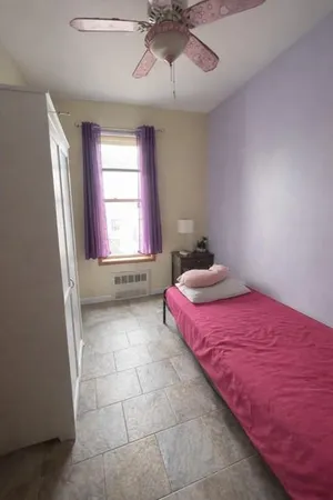 a bedroom with a bed and window