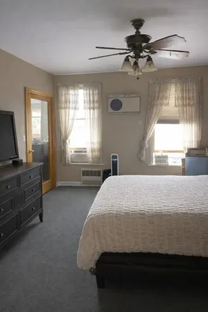 a bedroom with a bed and a window