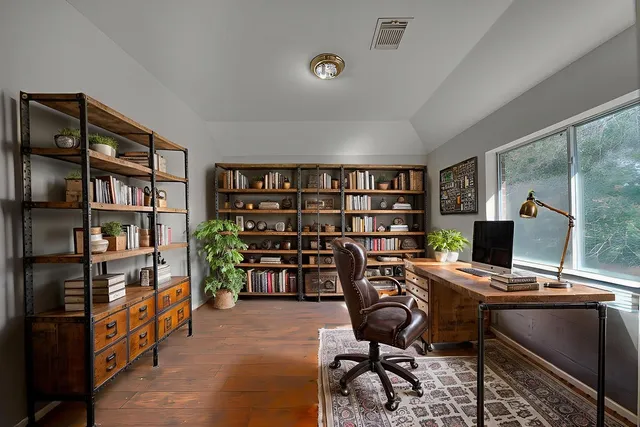 a view of staircase with railing and a window