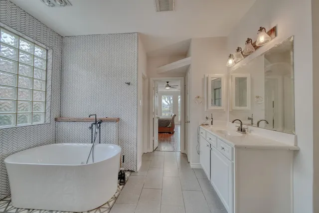 an aerial view of residential houses with outdoor space and lake view