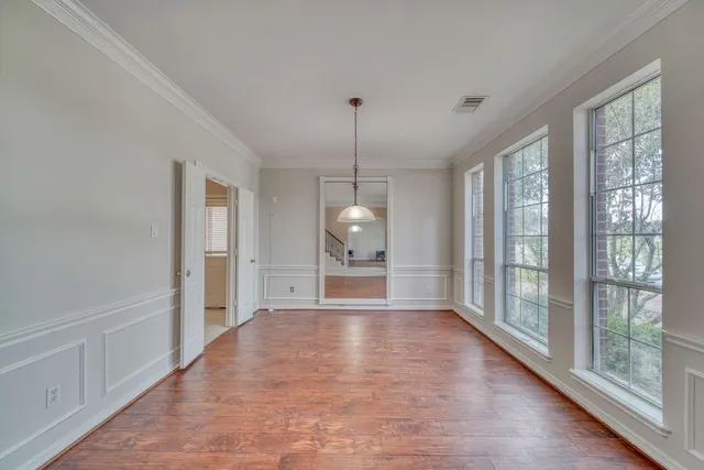 a living room with furniture a flat screen tv and a large window