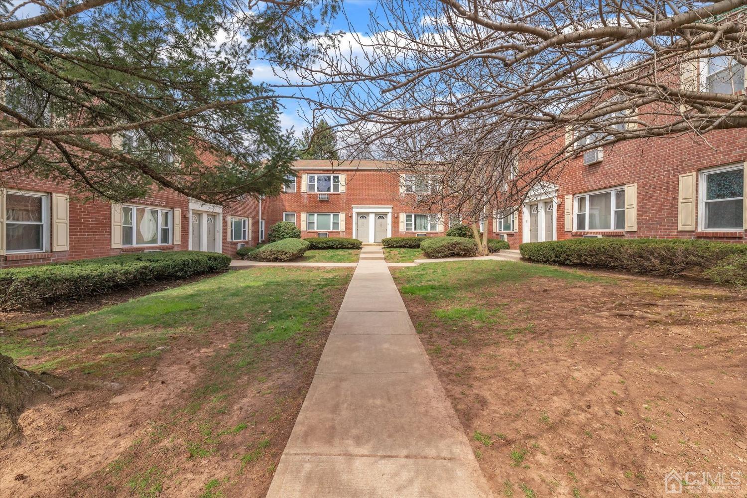 50 Fox Road, Unit 7A Edison, NJ 08817 - Photo 1 of 17 a view of a brick house next to a yard with big trees