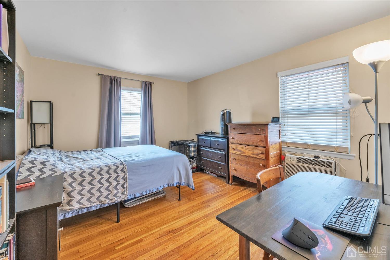 50 Fox Road, Unit 7A Edison, NJ 08817 - Photo 8 of 17 a bedroom with a bed and wooden floor