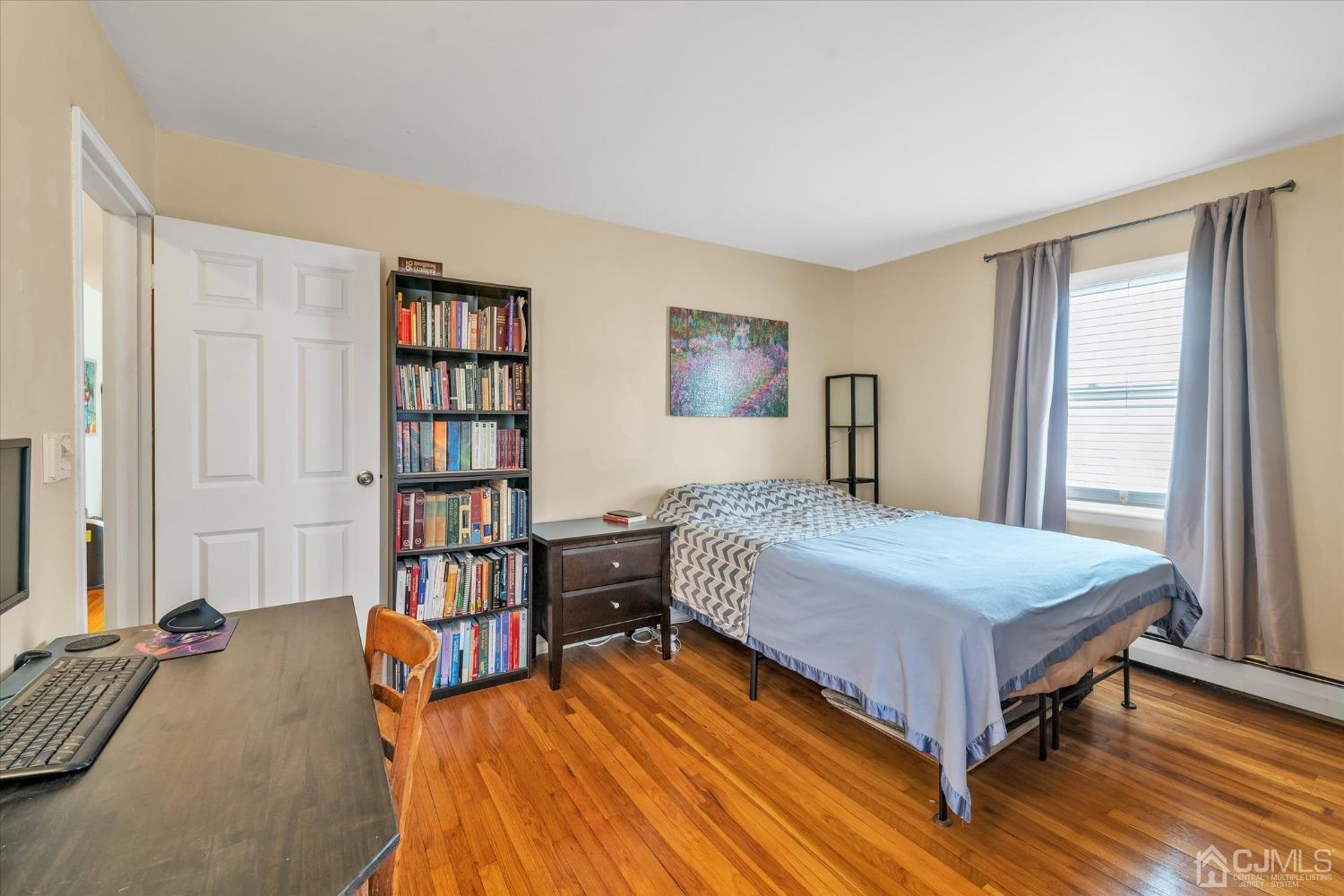 50 Fox Road, Unit 7A Edison, NJ 08817 - Photo 9 of 17 a bedroom with a bed and a book shelf