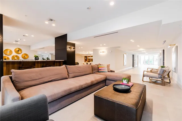 a living room with furniture and a lamp