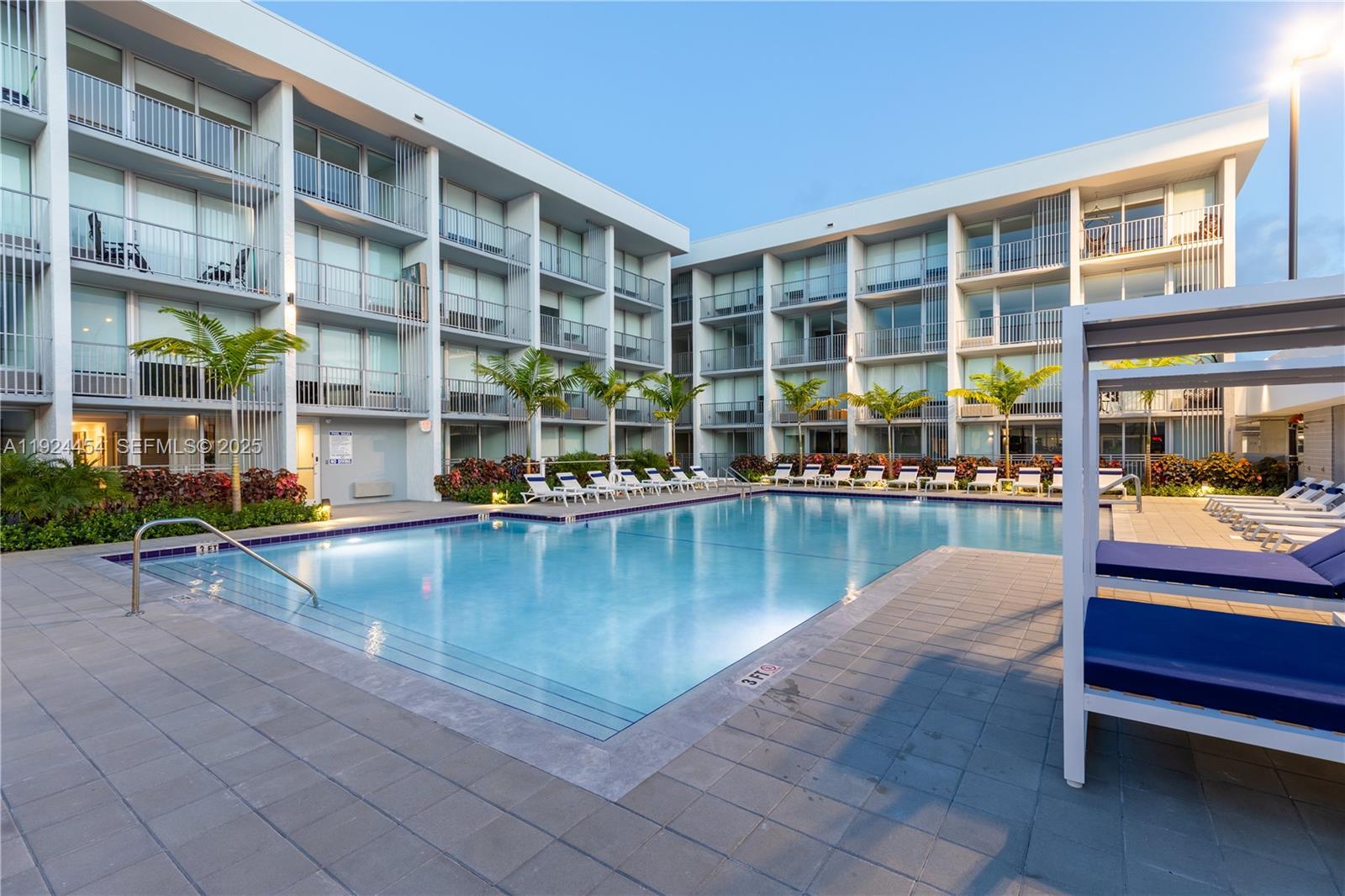 1950 West 49th Street, Unit 108 Hialeah, FL 33012 - Photo 23 of 39 a view of a swimming pool with a lounge chairs