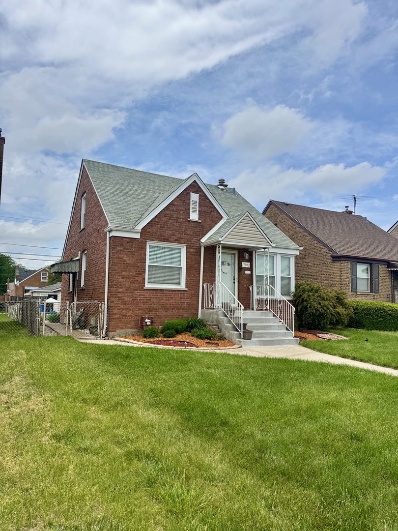 11042 South State Line Road Chicago, IL 60617 - Photo 2 of 12 a front view of a house with a yard
