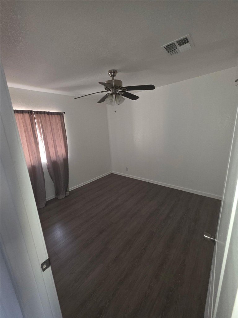 512 E Street Needles, CA 92363 - Photo 12 of 20 wooden floor in an empty room with a window