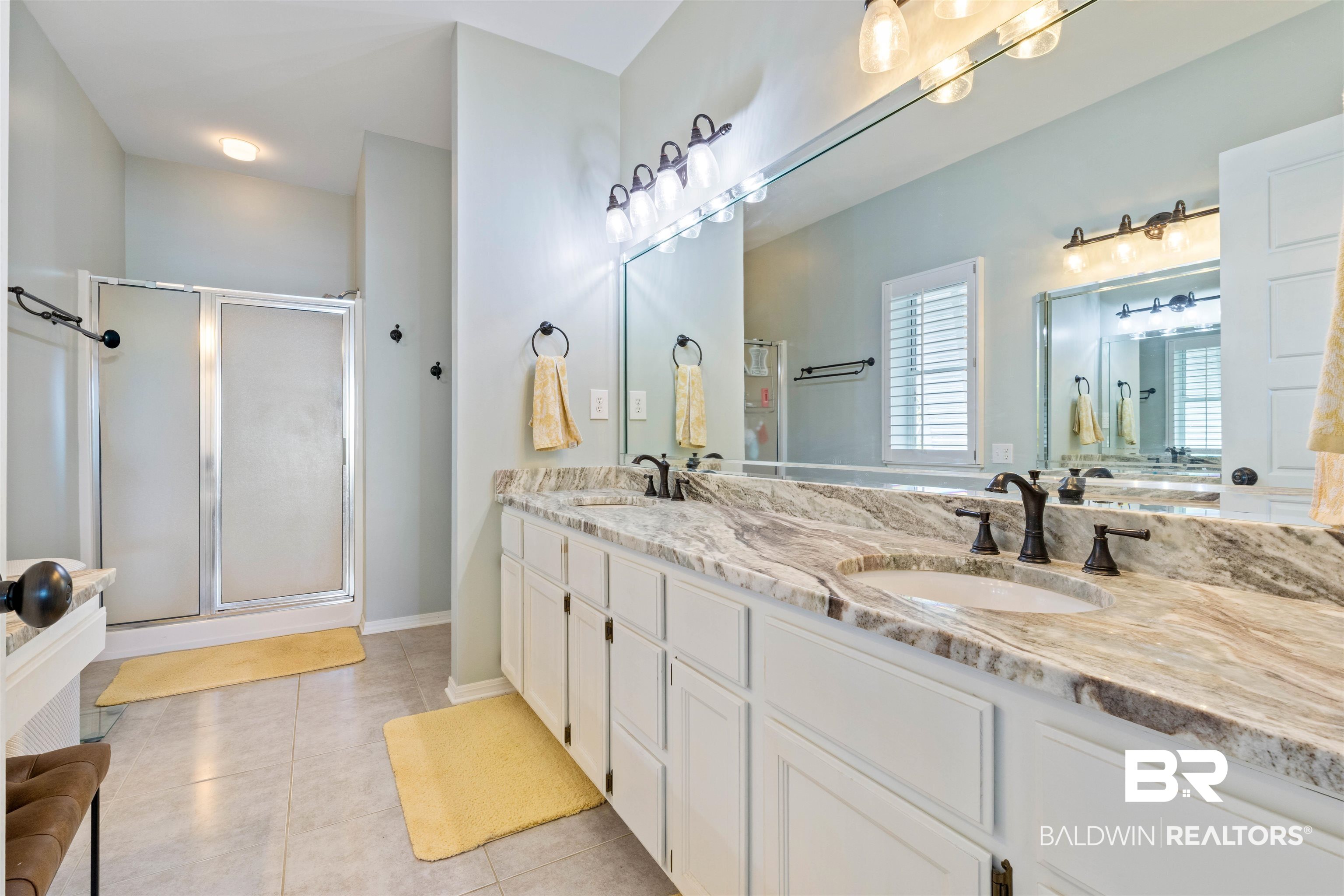 32315 River Road Orange Beach, AL 36561 - Photo 32 of 68 Full bathroom featuring double vanity, a stall shower, and light tile patterned flooring