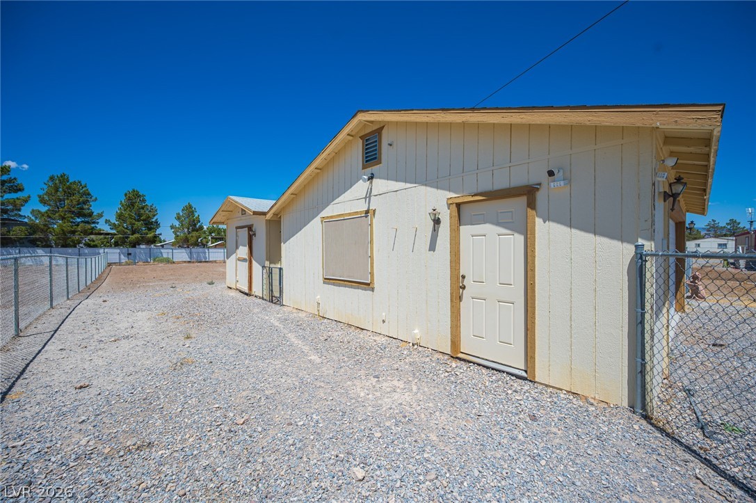 3200 Maple Road Pahrump, NV 89048 - Photo 44 of 53 A fenced yard provides secure outdoor space alongside the home's exterior.