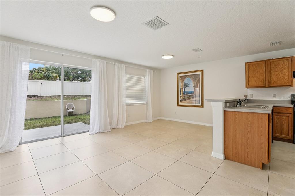 263 Sterling Springs Lane Altamonte Springs, FL 32714 - Photo 5 of 22 a view of an empty room with window and cabinet