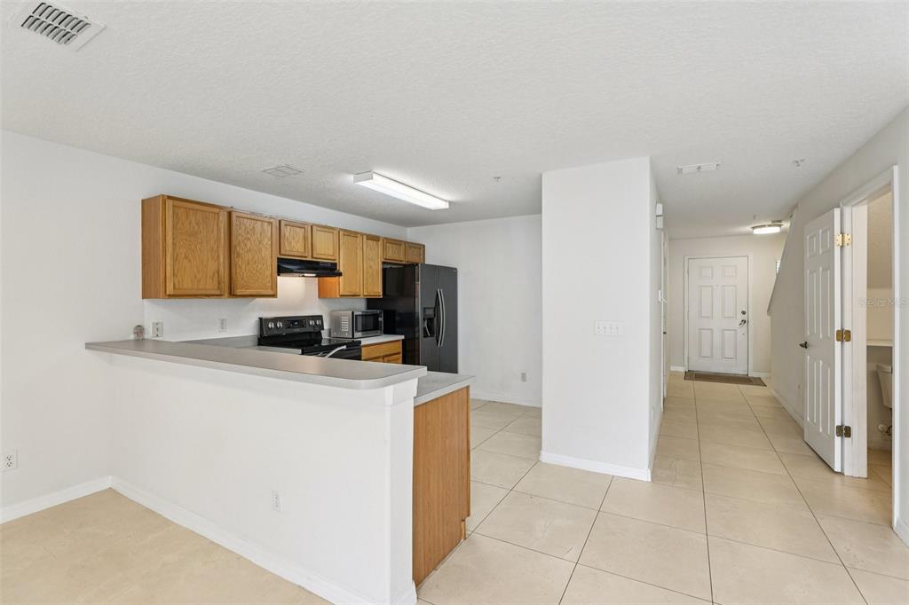 263 Sterling Springs Lane Altamonte Springs, FL 32714 - Photo 8 of 22 a kitchen with a refrigerator a stove top oven a sink and dishwasher