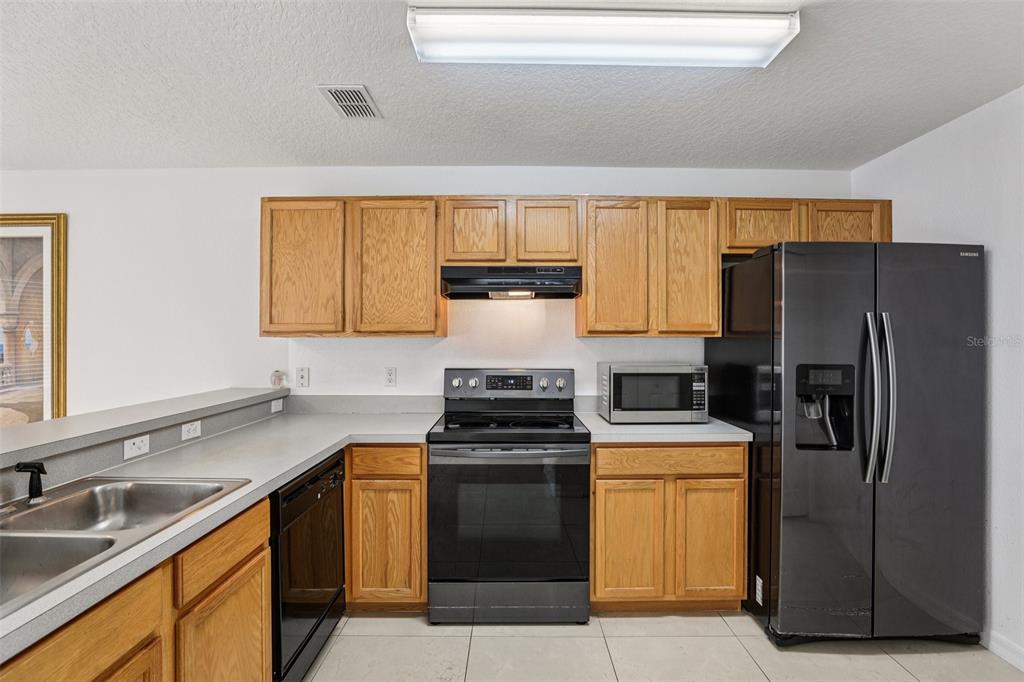 263 Sterling Springs Lane Altamonte Springs, FL 32714 - Photo 9 of 22 a kitchen with a stove sink and refrigerator